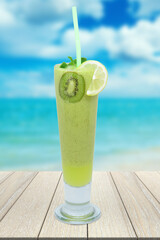 Kiwi juice cup. A refreshing summer drink with a piece of lemon and mint for garnish