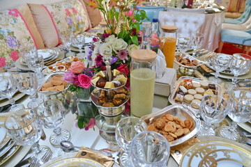 Moroccan salon with wedding table plates, cups and chairs