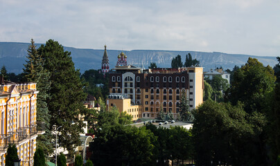 Fototapeta na wymiar panoramic view of the historic city center with a church and buildings among green trees on a sunny summer day in kislovodsk
