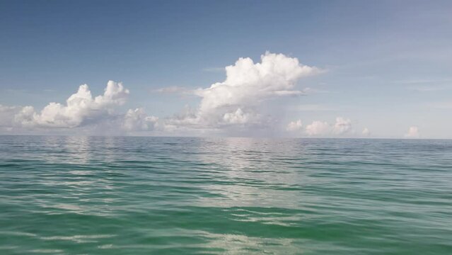 Low level aerial over Florida's gulf coast with beautiful clouds