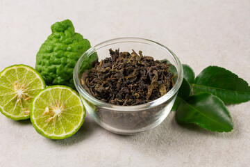 Bergamot tea or Earl Grey tea in transparent glass bowl and fresh bergamot fruit on white background.
