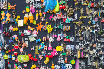 Fototapeta na wymiar Quirky earrings displayed at Brick Lane market in London, England