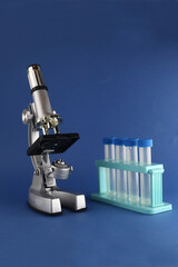 set of chemical utensils - microscope and test tubes isolated on blue background