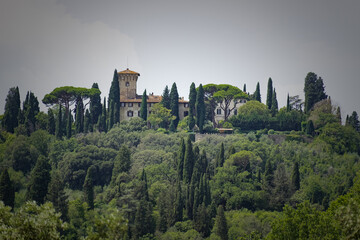 Fototapeta na wymiar A view of a Tuscan hill with castle on top 