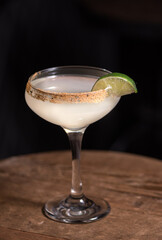 white cocktail with lime garnish 