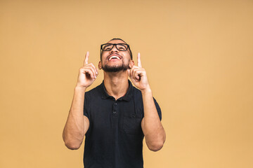 Portrait of happy young african american black man with in casual smiling, pointing up with...