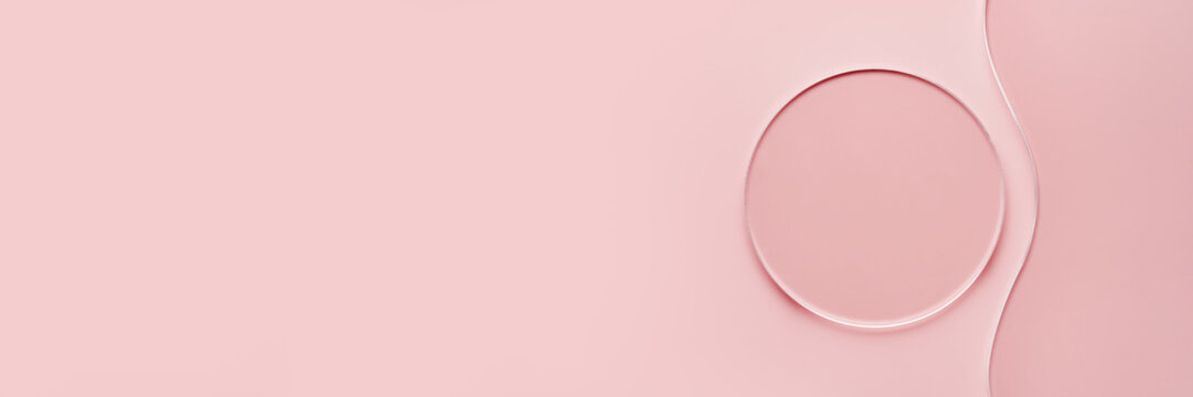 Empty round petri dish and wavy glass slide on pink banner. Mockup for cosmetic or scientific product sample