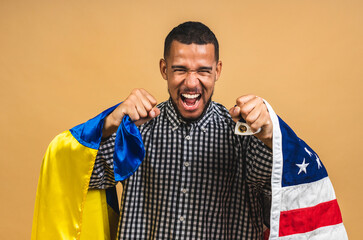 Portrait of positive african american black guy holding usa and ukrainian flags, isolated over...