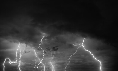 Fork lightning striking down during summer storm