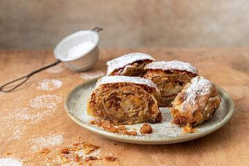 Homemade traditional Apple strudel on a wooden background
