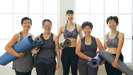 Portrait of Multi-generation woman, diverse age in family workout exercise and practice yoga together at gym