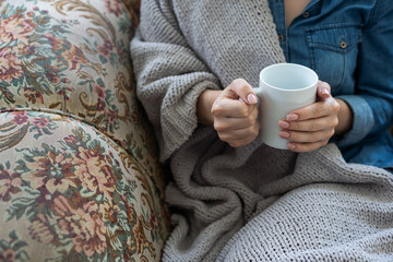 warm cup of hot coffee warming in the hands of a girl.