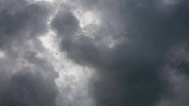 Abstract dark clouds or smoke background in slow motion. Gray clouds on rainy weather.
