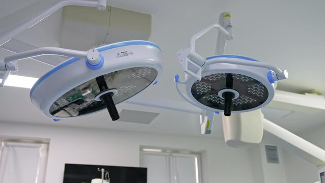 Switched off big lamps in modern surgical room. Equipment of present day operational theatres from low angle view.