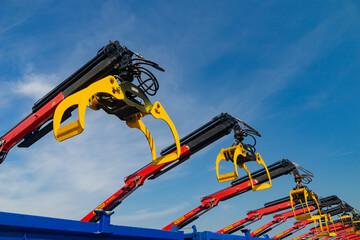 Crane manipulator with a gripper on the platform of the truck. A range of new equipment, ready to work