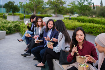 Group of workers taking a break in financial district and eating healthy food