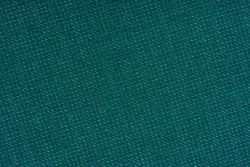 The background is made of green. blue material. Fabric for sewing clothes in a dark shade. Texture