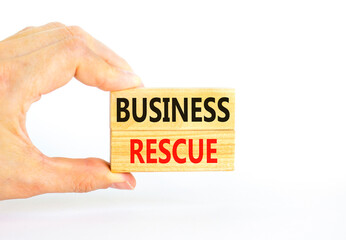 Business rescue symbol. Concept words Business rescue on wooden blocks on a beautiful white table white background. Businessman hand. Business rescue and support concept. Copy space.