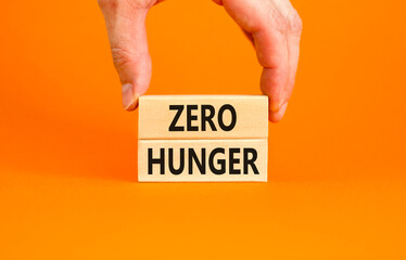 Zero hunger symbol. Concept words Zero hunger on wooden blocks on a beautiful orange table orange...