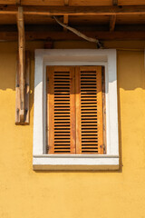 Window with closed wooden shutters.