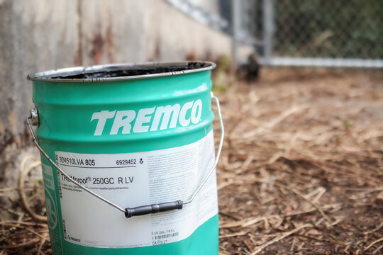 Large bucket of waterproofing membrane. Polymethyl methacrylate product to waterproof backfilled walls, green concrete, split slabs and planters. Selective focus.