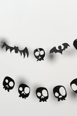 Bats and skulls black on white background, place to write greeting.