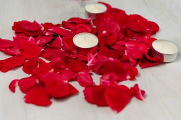Rose petals and scented candles on the floor.