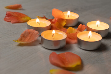 Obraz na płótnie Canvas Rose petals and a set of scented candles, a romantic evening.