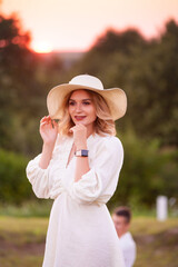 beautiful young woman in white dress and hat on the lavander field