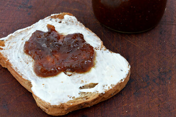 toast with cream cheese and fruit jam. Context breakfast or snack