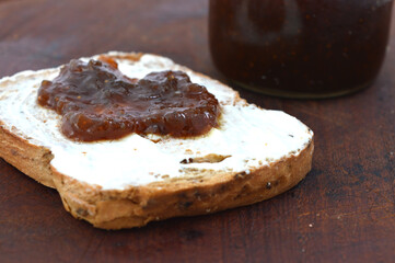 toast with cream cheese and fruit jam. Context breakfast or snack