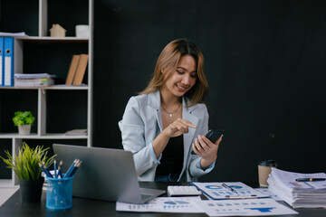 Fototapeta premium Young business women working and typing on laptop with happy and smile face on office spec.