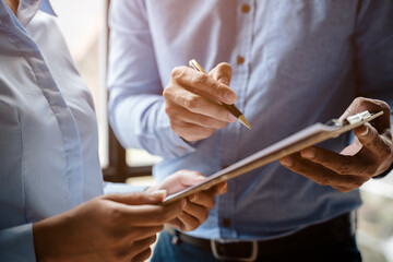 Obraz premium Close up of hands are working and brainstorming on paperworks about business financial and marketing with ray light.