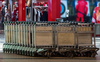 Metal luggage trolleys in the passenger terminal of the international airport.
