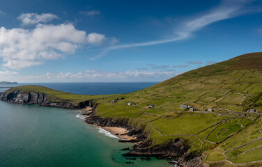 landscape view of the turquoise waters and golden sand beach at Slea Head on the Dingle Peninsula of County Kerry