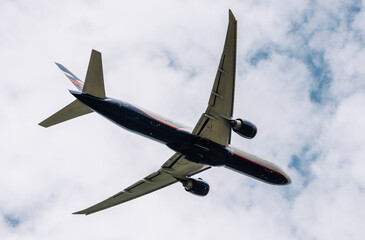 Passenger plane comes in for landing in cloudy weather.