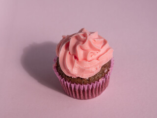 Cupcake on a purple background with side lighting and a place for text
