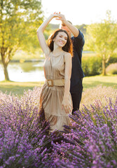 Fototapeta na wymiar Photo of young people dating and walking together outdoor in lavender field