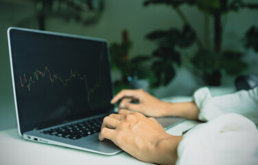 Close up, hand of businessman 30s looking stock tickers or graphs cryptocurrency trading platforms...
