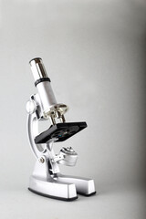 microscope isolated on gray background. Image contains copy space