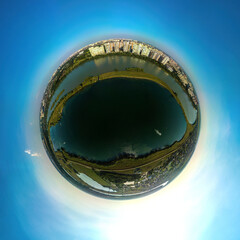 over Lake Starobzhegokai near the Kuban River and the western outskirts of the city of Krasnodar in the South of Russia - a small planet aerial panorama on a summer sunny day - obrazy, fototapety, plakaty