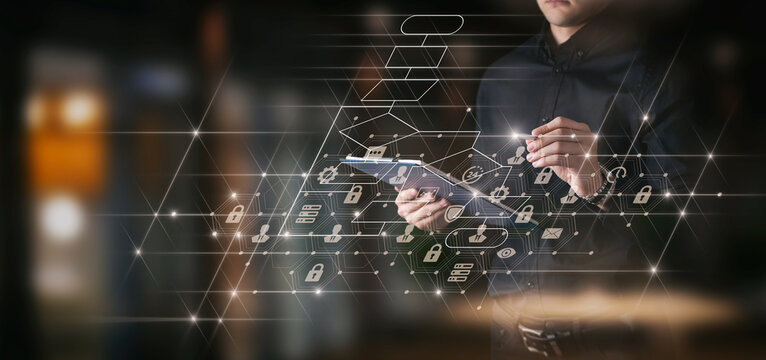 Businessman works on a tablet on a blurred evening city.
