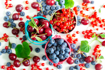 Mix of fresh berries in small buckets. Juicy summer wallpaper.