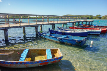 Fototapeta na wymiar wooden fishing rafts moored beside a deck on tropical beach