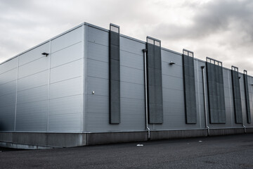 Exterior of a grey warehouse building.