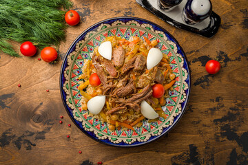 Pilaf festivities with beef and nut on old wooden table top view
