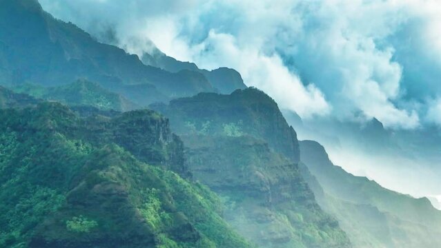 Epic aerial above Hawaii coast landscape, panoramic views on Na Pali coast park with green tropical jungle mountain peaks covered by dramatic rain clouds. Beautiful Nature of North Shore Kauai island