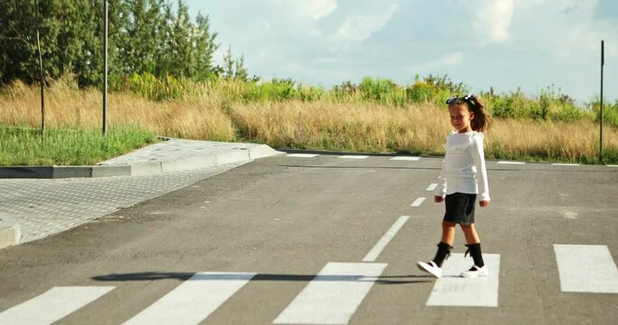 schoolgirl crosses the road at a pedestrian crossing