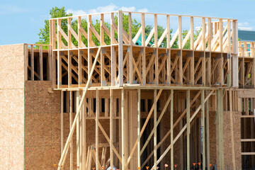 construction of a plywood house against the blue sky framing wall