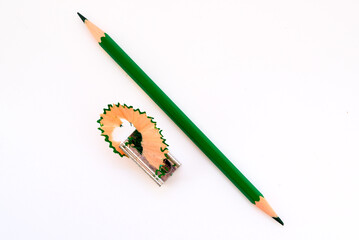 green graphite pencil for drawing and pencil sharpener on a white background